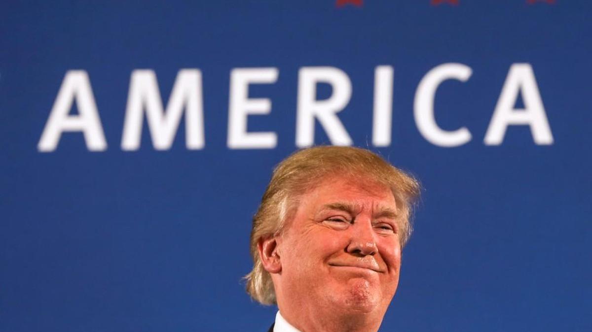 Republican presidential candidate Donald Trump receives applause after speaking at a town hall meeting at Atkinson Country Club in Atkinson, N.H., Monday.