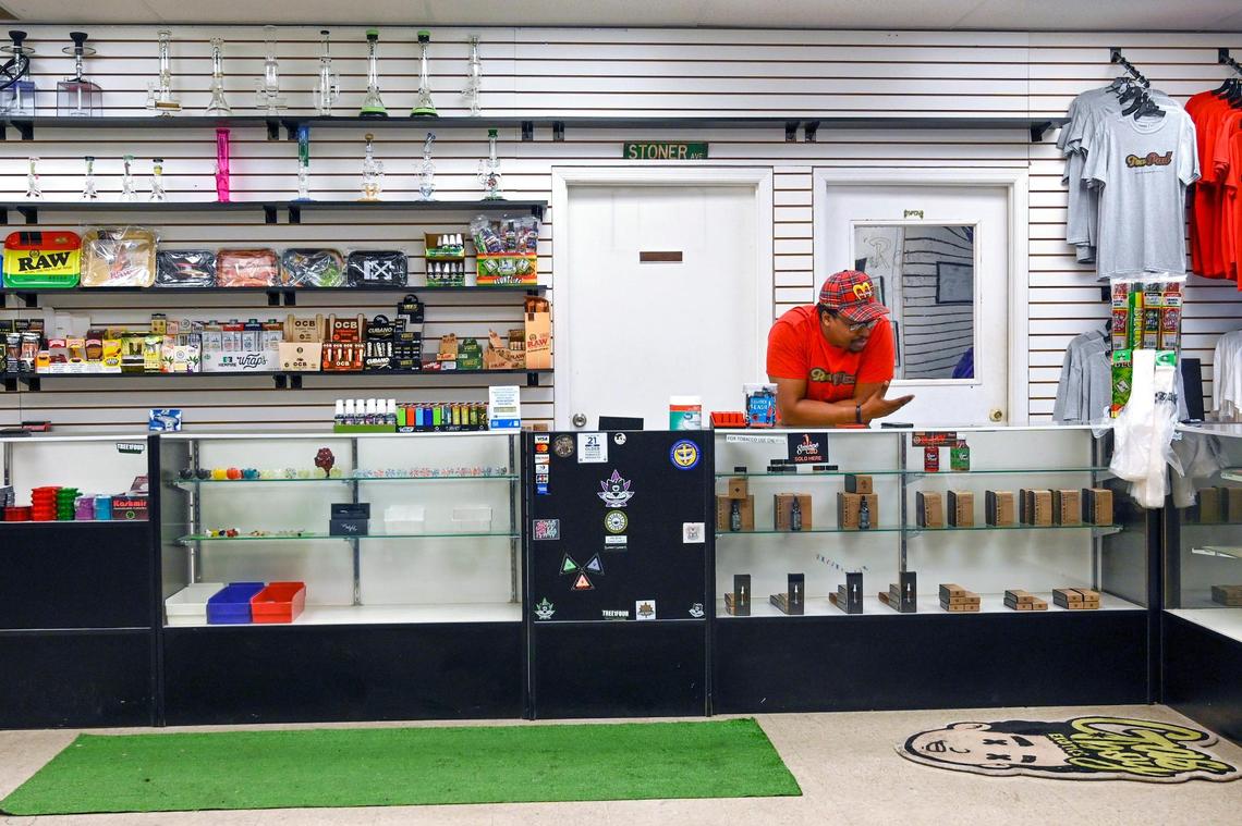 Andrew McDowell talks on the phone to a customer about a medical marijuana card on Tuesday, Sept. 6, 2022, at Funky Skunk, a retail smoke shop in Raytown, Missouri, that sells CBD, helps patients get medical marijuana cards and hosts marijuana-smoking events