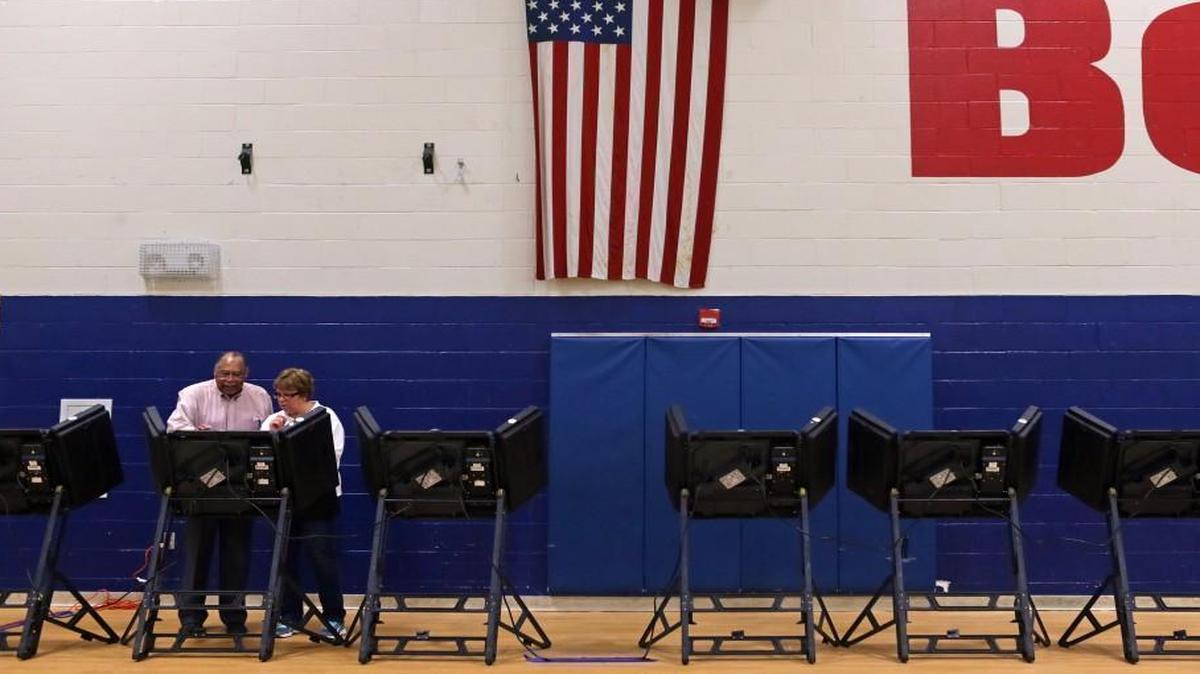 A polling place supervisor demonstrates a voting machine in St. Louis. Donald Trump and Hillary Clinton probably won the state, but overseas votes could still change the outcome.