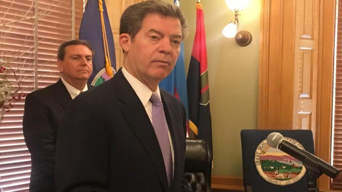 Gov. Sam Brownback announced plans Tuesday to bring high-speed internet to schools across the state. Listening to the announcement was Randy Watson, state education commissioner.