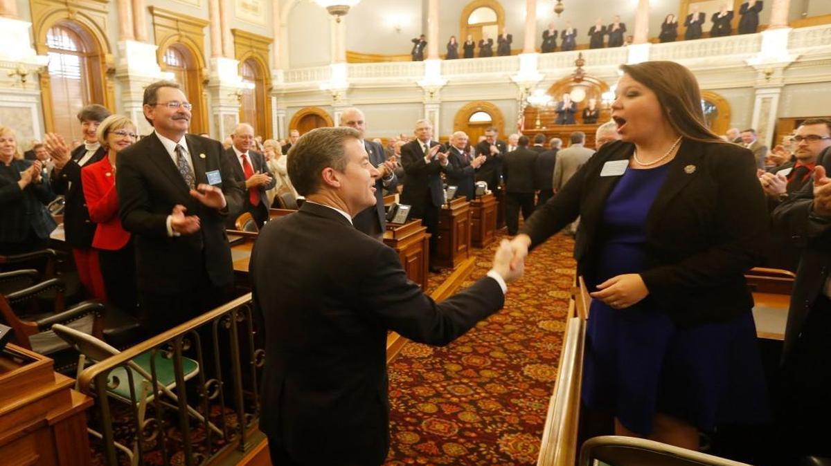 Kansas Gov. Sam Brownback shook hands with Rep. Stephanie Clayton of Overland Park as he entered the House Chambers on Tuesday.