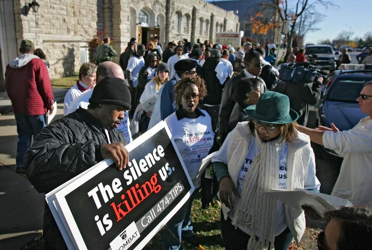 In this 2005 file photo, volunteers from the Jackson County COMBAT anti-violence program lined up outside the Metropolitan Missionary Baptist Church to pick up signs encouraging neighbors to report criminal activity to police. COMBAT is the Community Backed Anti-Crime Tax.