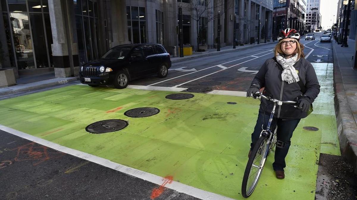 Kansas City has a new “bike box”designed to improve safety and give cyclists a head start against motorists. The big, bright green painted box is at 11th and Petticoat Lane (Main Street), where 11th Street jogs and crosses the streetcar line. The painted striping is almost finished but additional decals and signage will be added. Deb Ridgway, standing in the bike box, is Kansas City’s bicycle pedestrian coordinator.