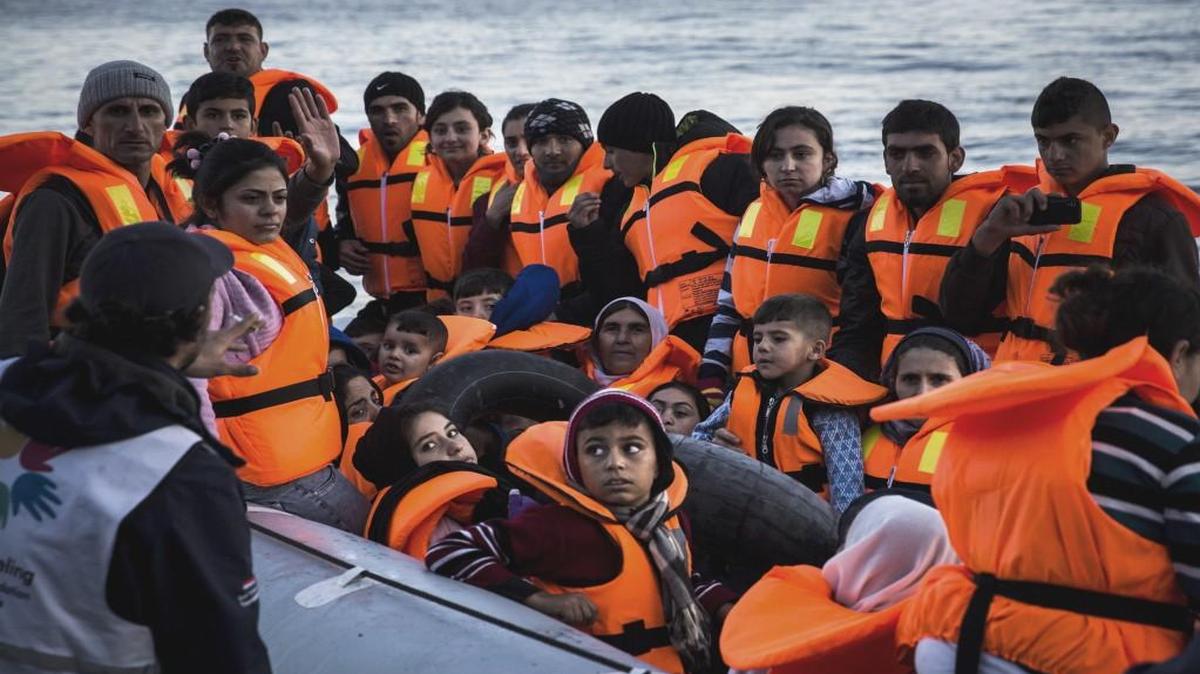 Syrian refugees disembark on the Greek island of Lesbos after crossing the Aegean sea on a dinghy from the Turkish coast.