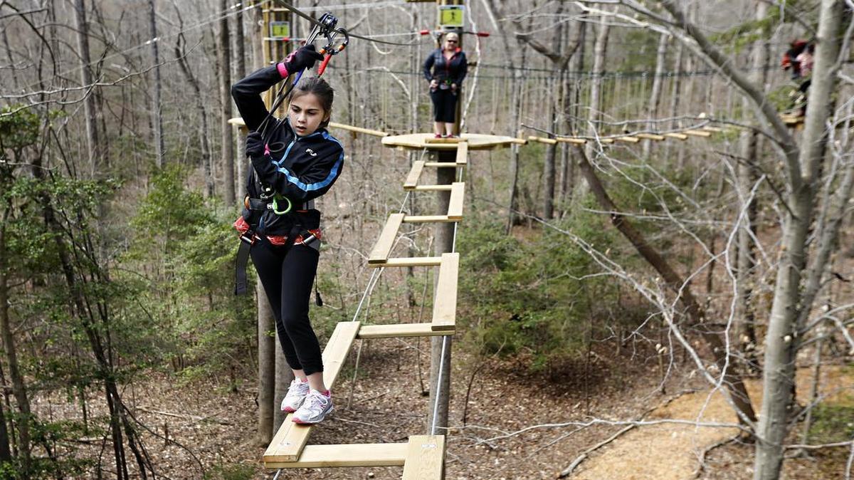 
Riley Free, 10, made her way across a suspended bridge in March at the Go Ape Zip Line & Treetop Adventure in Blue Jay Point County Park in Raleigh, N.C. Go Ape is now working with the Kansas City Parks and Recreation Department to create a similar attraction in Swope Park.
