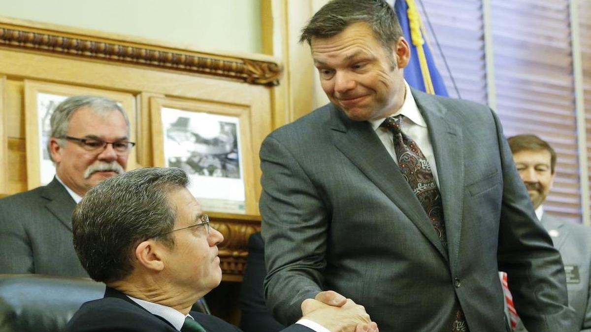Kansas Secretary of State Kris Kobach shook hands with Gov. Sam Brownback on in June at the Kansas Statehouse in Topeka after Brownback signed Senate Bill 34, which grants prosecuting power to the secretary of state for cases of voter fraud.