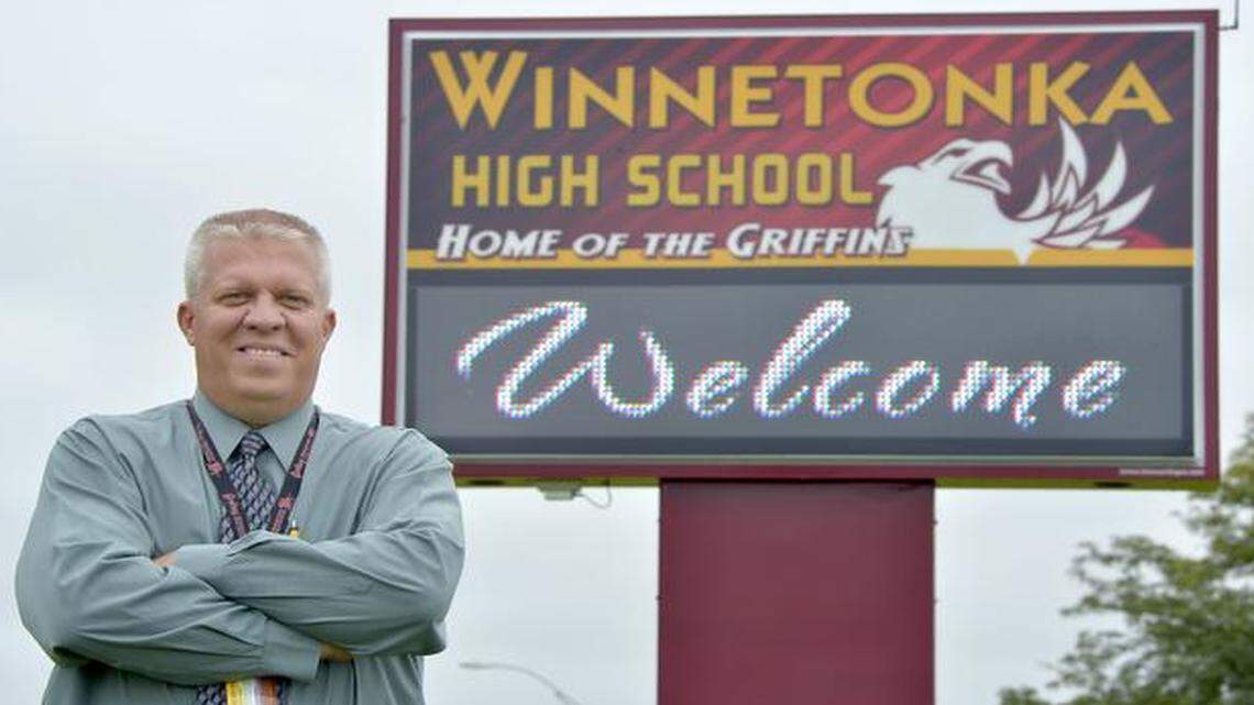 
Winnetonka High School principal Matt Lindsey is shown by a digital sign outside his school. The North Kansas City School District installed non-conforming signs at three of its schools — Oak Park and Winnetonka high schools and New Mark Middle School — within the Kansas City city limits. The Kansas City Council is debating new digital sign regulations that could accommodate neighborhoods, schools and churches.
