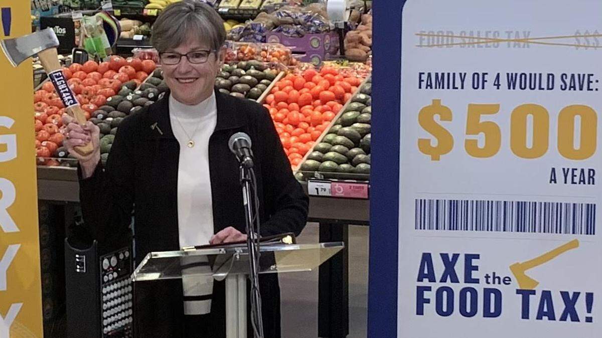 House Majority Leader Dan Hawkins, R-Wichita, says Republicans did the real work of cutting the food tax while Gov. Laura Kelly was campaigning with a hatchet, as in this appearance at a Topeka supermarket.