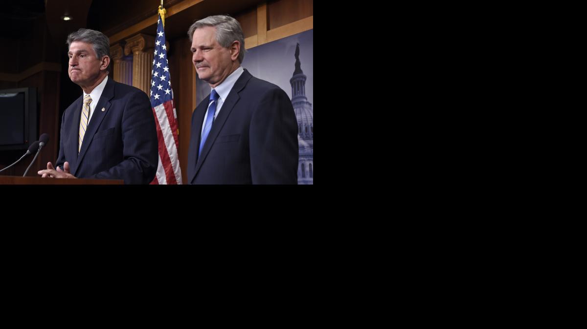 
Sen. Joe Manchin, D-W.Va., left, and Sen. John Hoeven, R-N.D., during a news conference Tuesday on Capitol Hill in Washington, Tuesday
