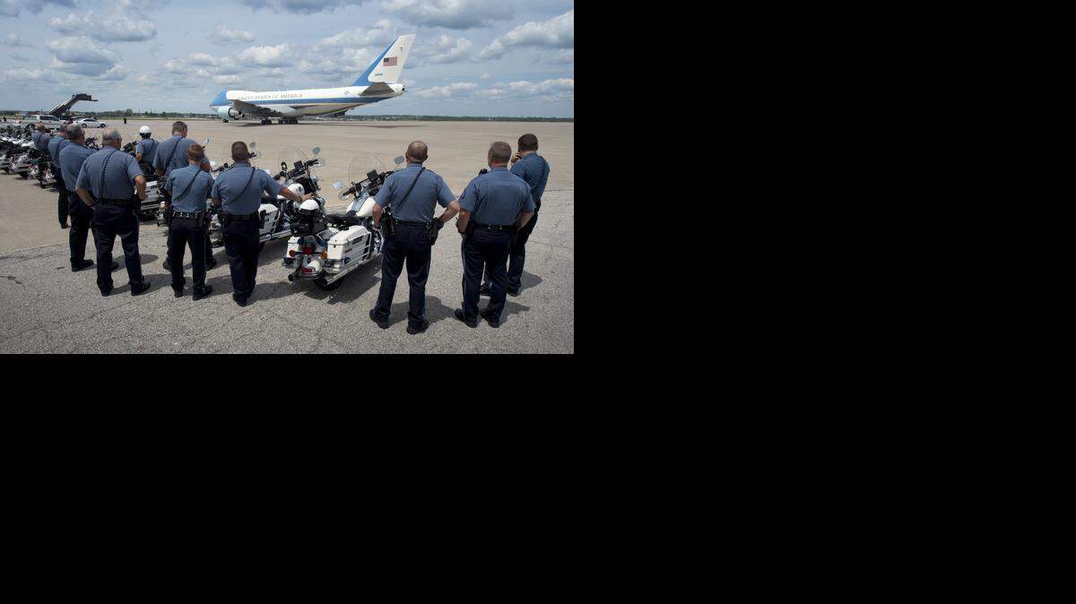 
Kansas City motorcycle officers watched as Air Force One carrying President Barack Obama taxied towards the runway on Wednesday, July 30, 2014, in Kansas City.
