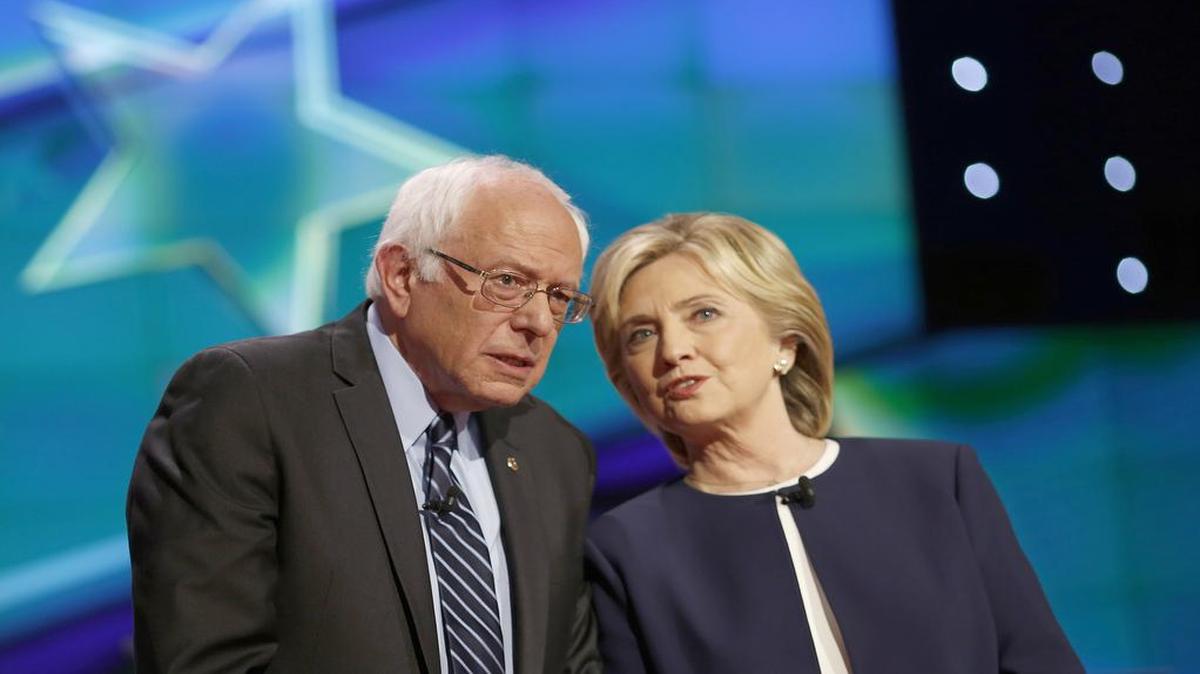 Sen. Bernie Sanders and Hillary Clinton spoke with each other onstage shortly before the start of the first Democratic presidential debate.