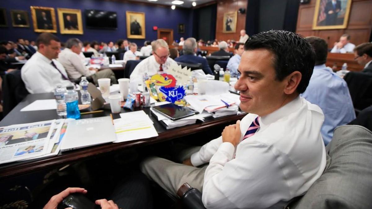 U.S. Rep. Kevin Yoder, a Kansas Republican, confers with a fellow lawmaker during a hearing on spending bills.