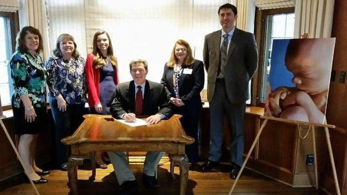 
A photo from Tuesday’s ceremony tweeted by the governor’s office showed Sam Brownback flanked by anti-abortion leaders and two large photos of fetuses. 
