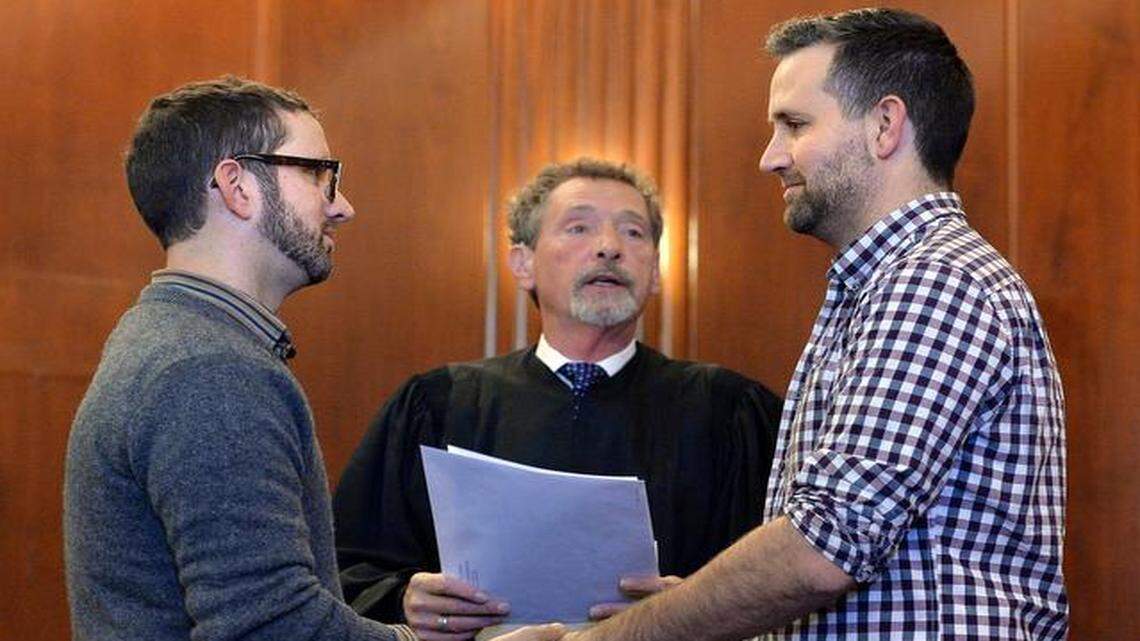 
When the Jackson County recorder of deeds began issuing same-sex marriage licenses Friday, Robert Gann (left) and John Kenny Rodricks (right) were first in line. Vernon Scoville, a retired associate circuit judge, officiated the ceremony in the legislative chambers of the county courthouse.
