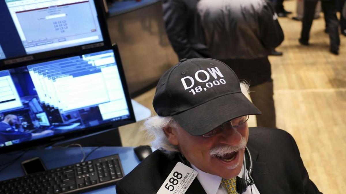 A trader wore a “DOW 18,000” hat on the floor of the New York Stock Exchange in December 2014 as stocks passed the 18,000-point mark into what was then record territory. The Dow now is set to pass 20,000.