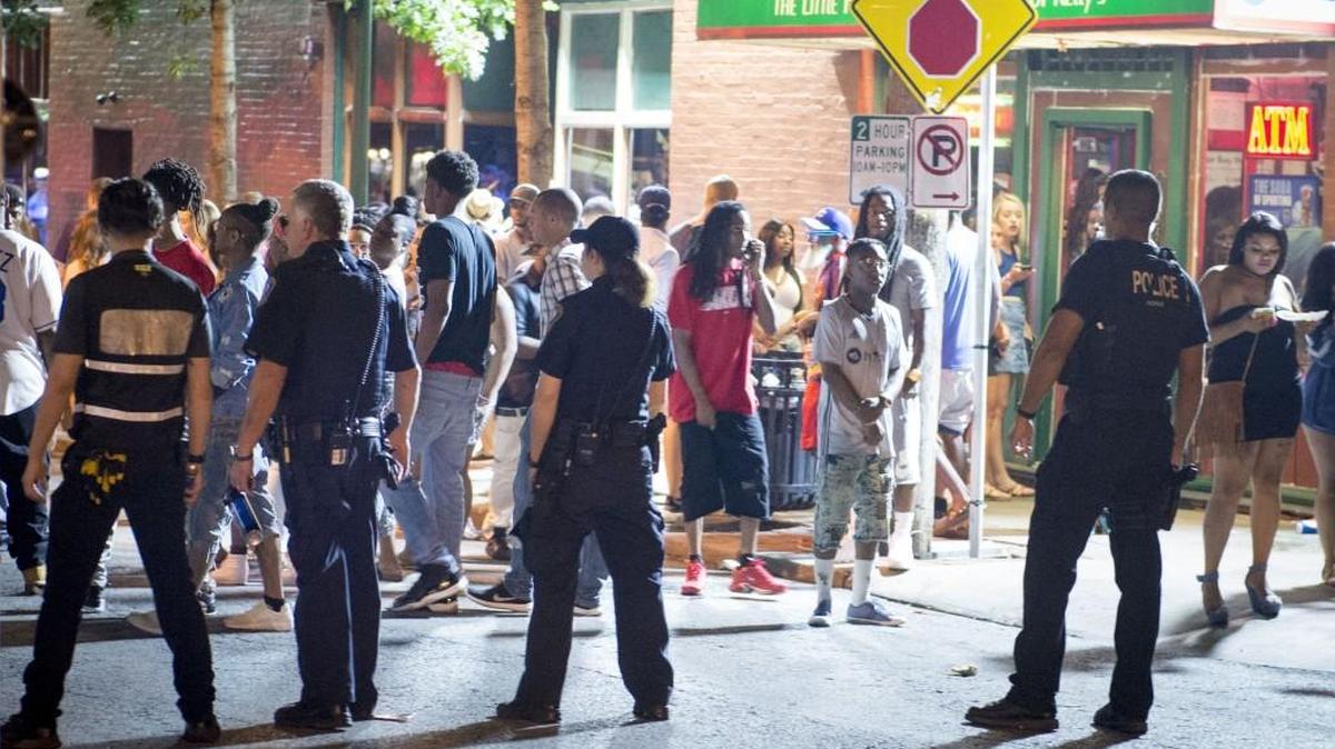 Westport Public Safety officers and Kansas City Police officers formed a line to watch the crowd as Kansas City officers escorted a woman from the bar district during what Kansas City police described as a typical Saturday night on July 30.