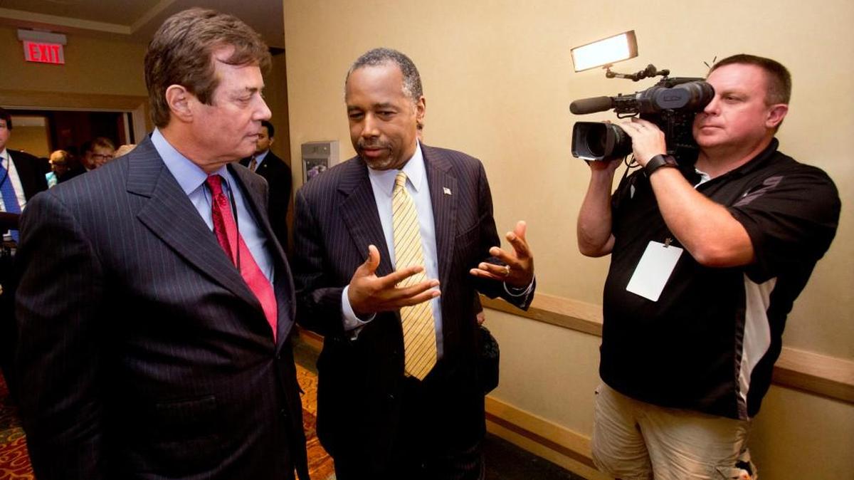 Donald Trump’s new strategist Paul J. Manafort, left, chats with former presidential candidate Ben Carson as they head to a Trump for president reception at the Republican National Committee Spring Meeting, Thursday in Hollywood, Fla.