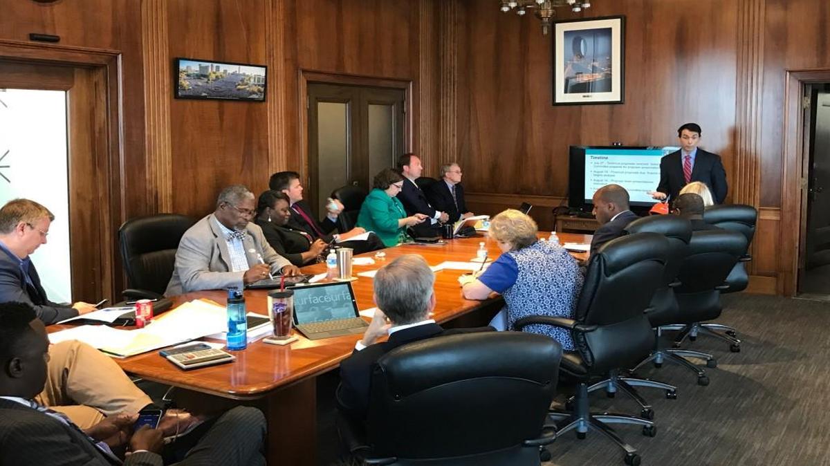 Charles Renner, standing, offers Kansas City Council members an outline of the selection process for a KCI single terminal developer.