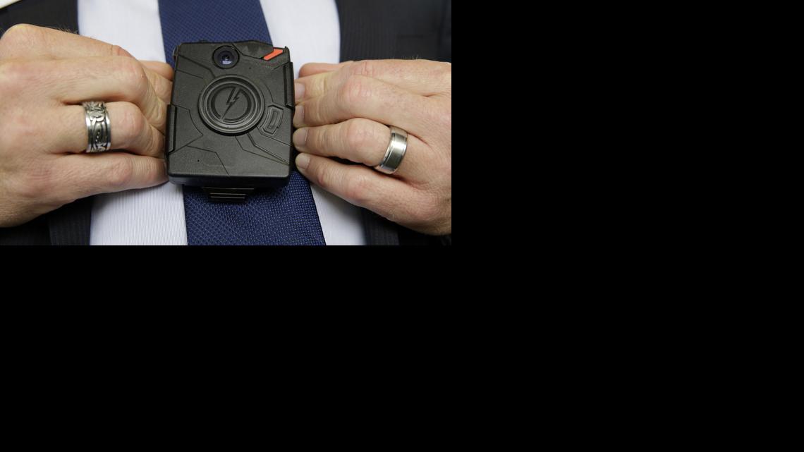 
Steve Tuttle, vice president of communications for Taser International, demonstrates one of the company's body cameras
