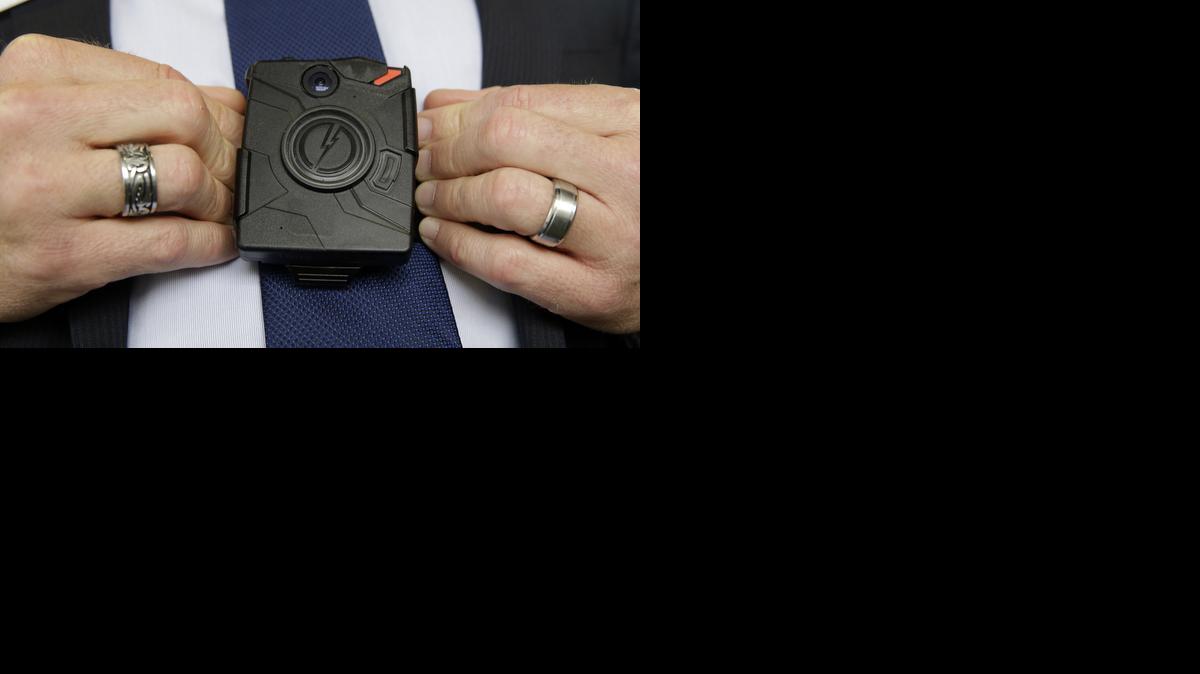 
Steve Tuttle, vice president of communications for Taser International, demonstrates one of the company's body cameras
