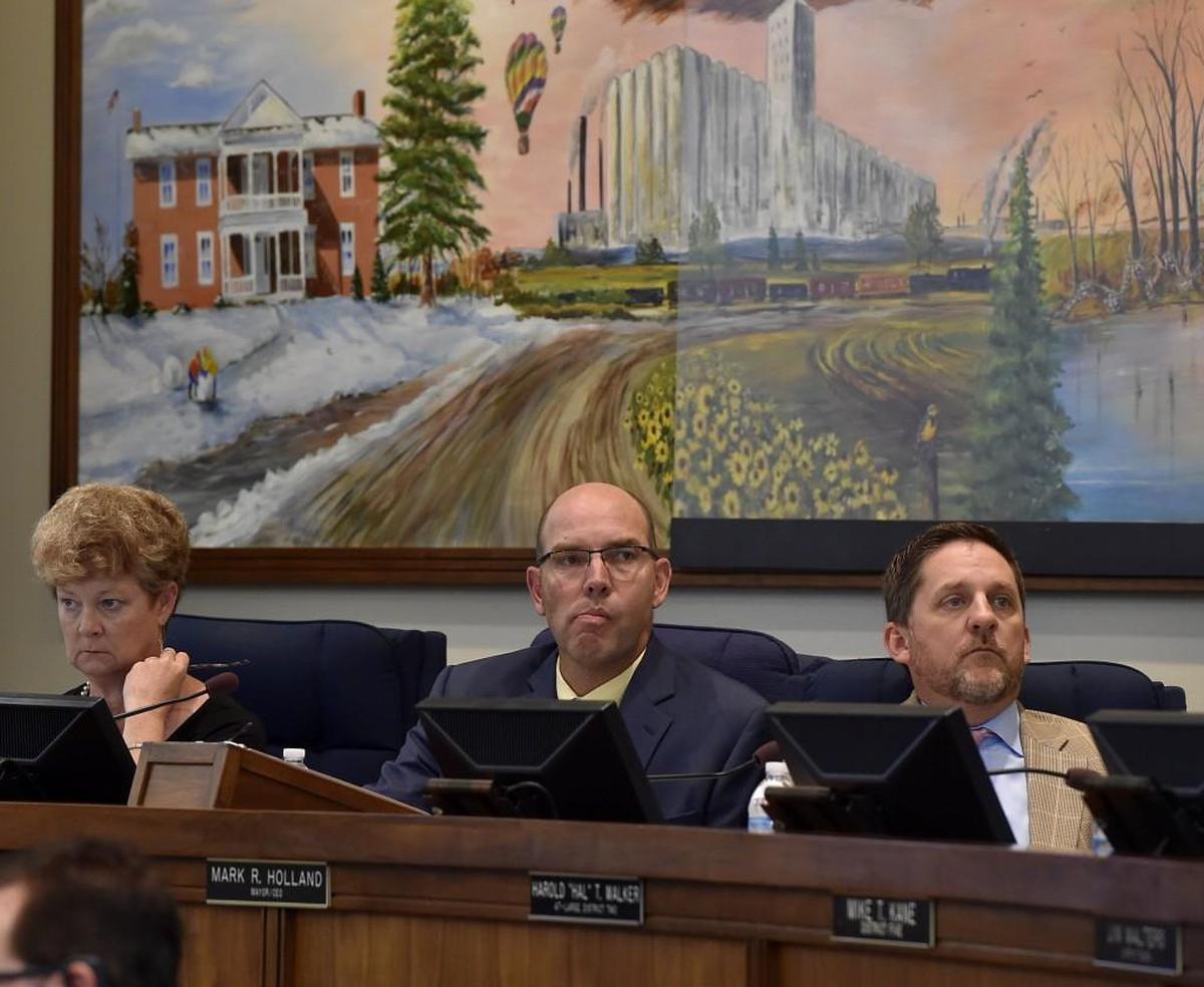 Recently retired county administrator Doug Bach, center, will receive a more than $813,800 from the Unified Government as part of a separation agreement.