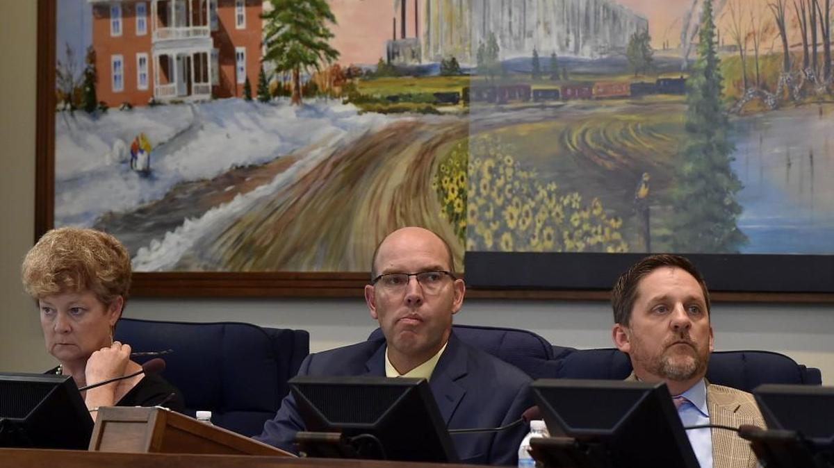 Recently retired county administrator Doug Bach, center, will receive a more than $813,800 from the Unified Government as part of a separation agreement.