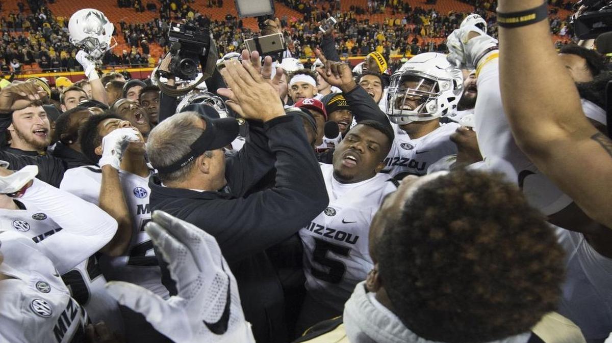 Then-coach Gary Pinkel (center) celebrated with his Missouri Tigers football team after beating BYU on Nov. 14 at Arrowhead Stadium. A week earlier, amid racial tension on campus, the team had threatened a boycott if the chancellor and university system president did not resign.
