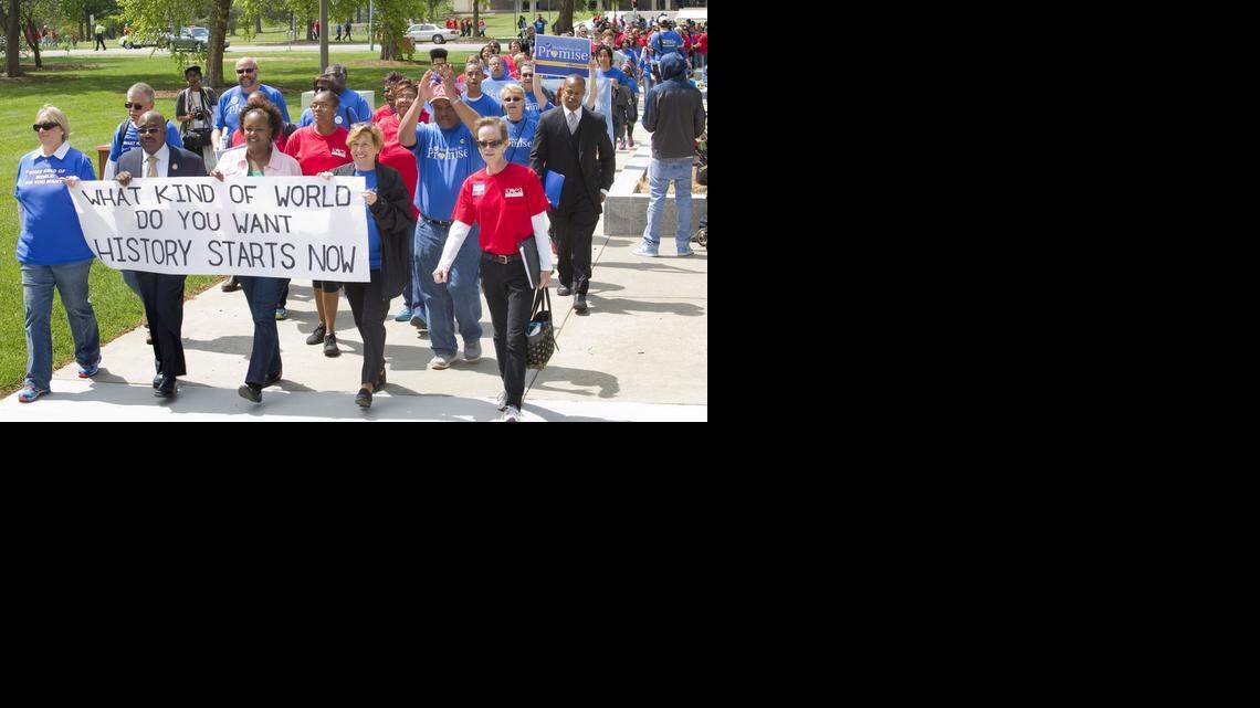 
In this May 17, 2014, file photo, members of the American Federation of Educators, wearing blue shirts, joined members of the Kansas National Education Association, wearing red shirts, to rally at the Statehouse in Topeka. Kansas teachers who watched over the last two years as legislators made changes to their profession are getting politically active this summer, hoping to persuade voters that it’s time for a change in Topeka.
