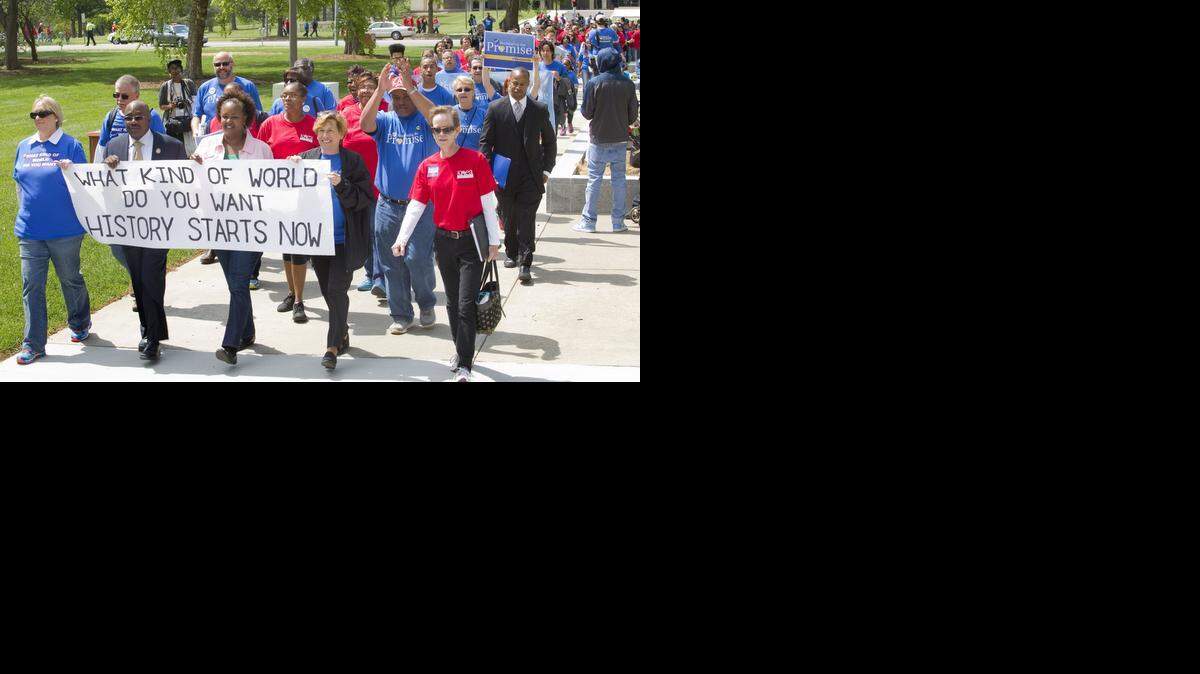 
In this May 17, 2014, file photo, members of the American Federation of Educators, wearing blue shirts, joined members of the Kansas National Education Association, wearing red shirts, to rally at the Statehouse in Topeka. Kansas teachers who watched over the last two years as legislators made changes to their profession are getting politically active this summer, hoping to persuade voters that it’s time for a change in Topeka.
