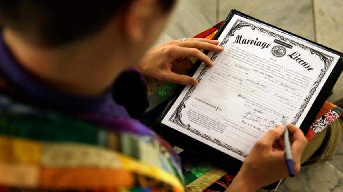 
The Rev. Katie Hotze-Wilton signed a Missouri marriage license after performing a marriage ceremony for April Dawn Breeden and her longtime partner, Crystal Pearis, on Wednesday at City Hall in St. Louis. Earlier in the day, St. Louis Circuit Judge Rex Burlison overturned Missouri’s ban on gay marriage, saying it was unconstitutional. 
