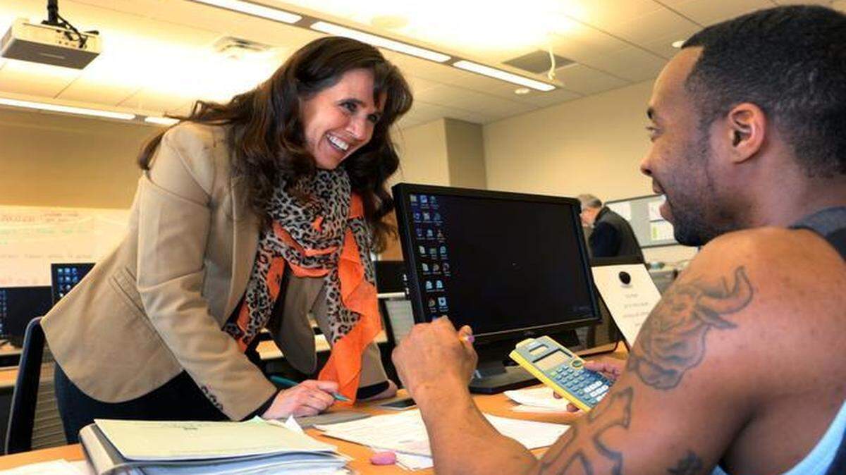 
Johnson County Community College GED instructor Michele Buescher says the cost of the new GED has had an impact on students. “I hear more students that have to spread it out,” Buescher says, referring to the test’s several sections. Here she talks over math problems with a student.
