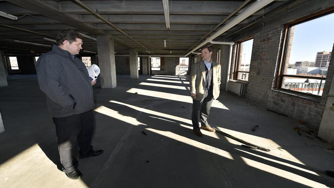 Tax incentives to renovate a site at 1640 Baltimore Ave. are being challenged. Craig Scranton (left) of BNIM and Peter Lacy of Lacy & Company toured the building, which BNIM hopes will house its headquarters.