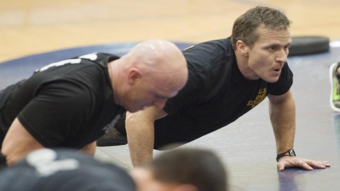 In this file photo, then Missouri Gov.-elect Eric Greitens (right) worked out with members of the Kansas City Police Department’s Tactical Response Team. Greitens — a former Navy SEAL — performed exercises with a group of police officers and a separate group of trainees.
