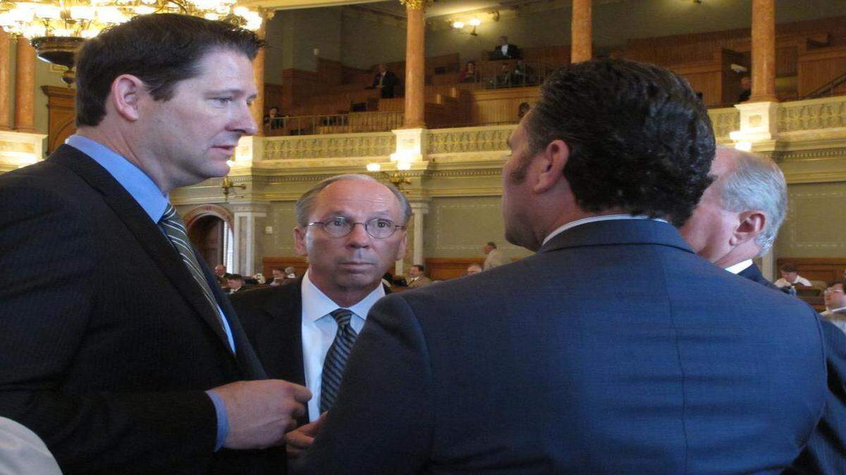Kansas House Appropriations Committee Chairman Ron Ryckman Jr. (left), an Olathe Republican, conferred with Rep. Marvin Kleeb (center), an Overland Park Republican, and Senate Ways and Means Committee Chairman Ty Masterson (front right), an Andover Republican, during a House session Saturday in Topeka. Ryckman and Masterson are negotiators of a plan to balance the state’s budget.