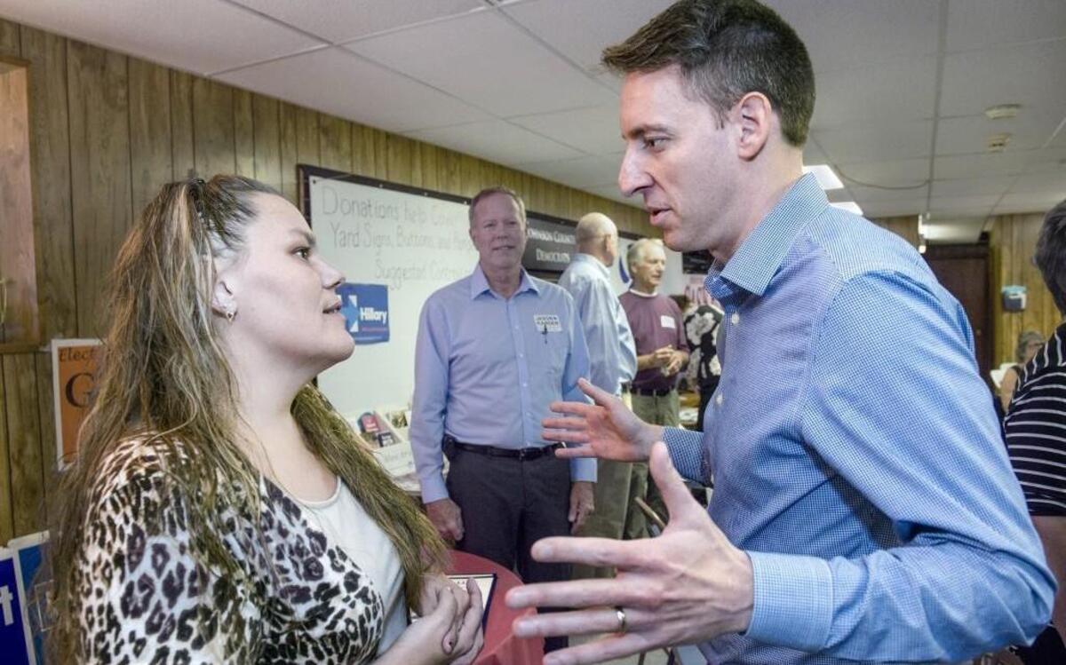 U.S. Senate candidate Jason Kander spoke with Naomi Stewart, an undecided voter from Knob Noster, on Thursday at the office of the Johnson County Democratic Party in Warrensburg. Kander is running against Republican incumbent Roy Blunt.