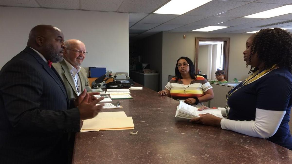Petitioners Vernon Howard Jr. (from left) and Sam Mann turned in signatures Friday to the City Clerk’s Office in Kansas City. They want a sales tax increase measure on the April ballot to benefit East Side development.