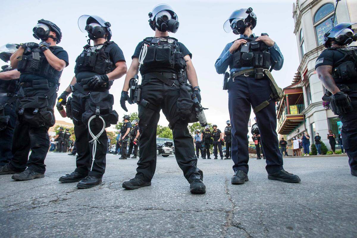 Kansas City police officers stand at the ready during a 2020 George Floyd protest at the Country Club Plaza.