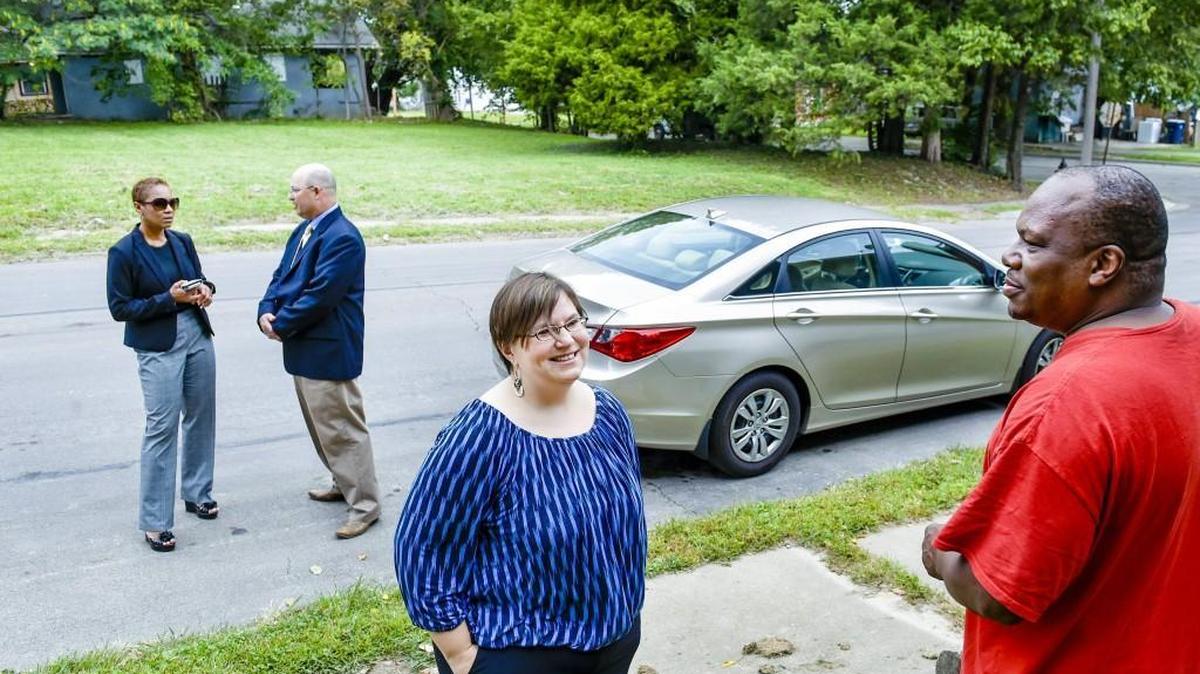 
Fresh Coast Capital co-founder April Mendez (center, facing camera) discussed with urban core resident Leaven Fountain (right) on Thursday, Sept. 17, 2015, the possibility of turning the vacant lot, pictured in the background, at 18th Street at Cypress Avenue in Kansas City into a tree-filled landscape. Behind Mendez and Fountain are Land Bank Executive Director Ted Anderson (right), who is teaming with Mendez to try to plant trees in vacant neglected lots, and Kimiko Gilmore, Assistant City Manager for Kansas City.
