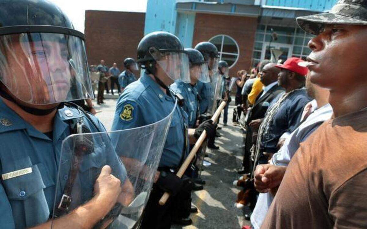 
Protesters locked arms as they confronted Missouri Highway Patrol troopers in front of the Ferguson police station on Aug. 11. 

 
