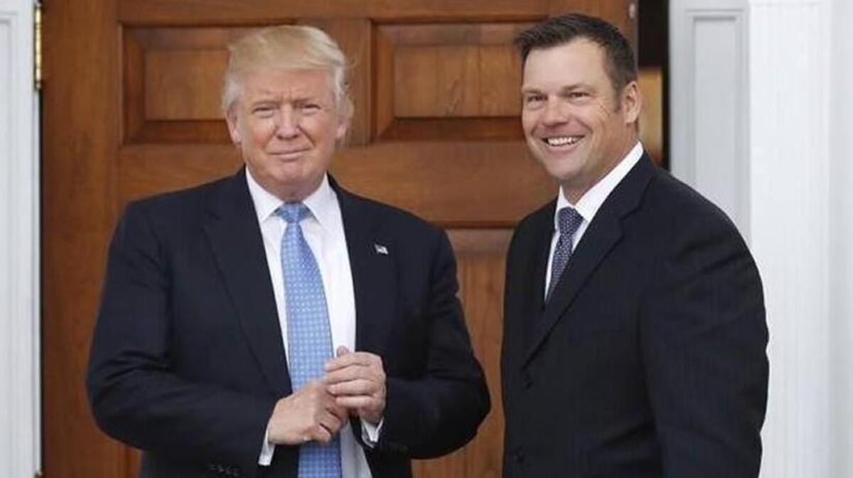 In this Nov. 20, 2016, file photo, Kansas Secretary of State Kris Kobach holds a stack of papers as he meets with then President-elect Donald Trump in Bedminster, N.J.