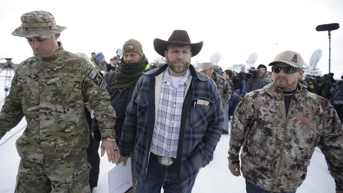 Ammon Bundy, center, one of the sons of Nevada rancher Cliven Bundy, walks off after speaking at a news conference at Malheur National Wildlife Refuge headquarters in January.