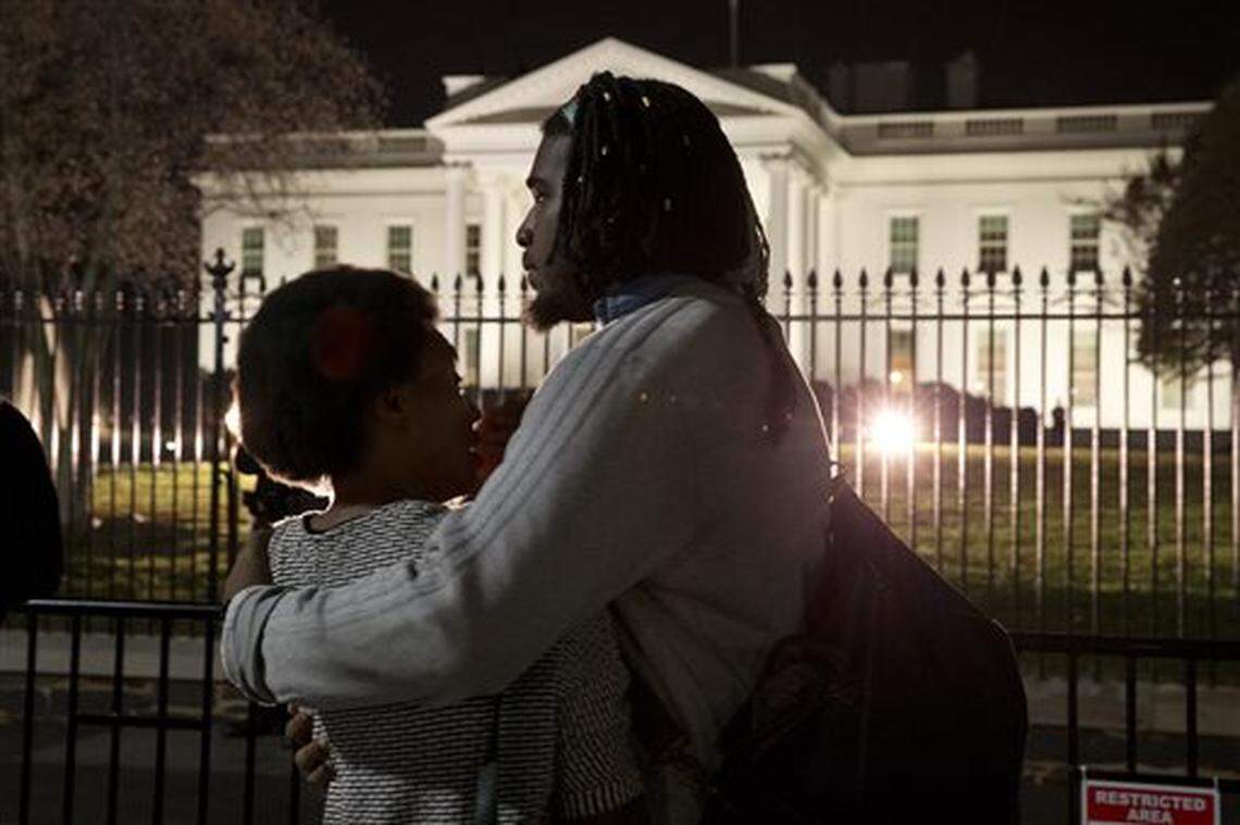 Bonnie Mills, 19, left, a junior at Howard University, is hugged by a friend, who asked not to be named, as they gather with students from Howard University and others in front of the White House Monday, Nov. 24, 2014, in Washington, in reaction to the Ferguson grand jury decision not to indict police officer Darren Wilson in the shooting death of Michael Brown. “We were sitting in the student lounge waiting for the verdict,” says Mills, “and the fact that he won’t even go to trial really affected us.” (AP Photo/Jacquelyn Martin)