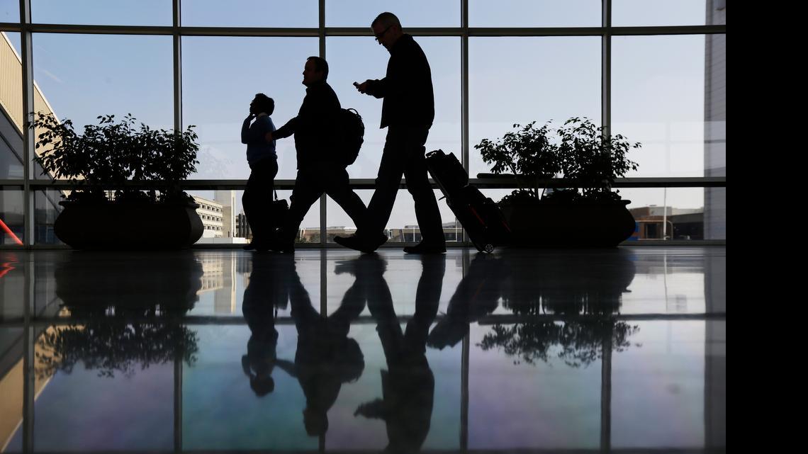 
Travelers pass through a corridor at Philadelphia International Airport in Philadelphia. The U.S. government is investigating possible collusion between major airlines to limit available seats.
