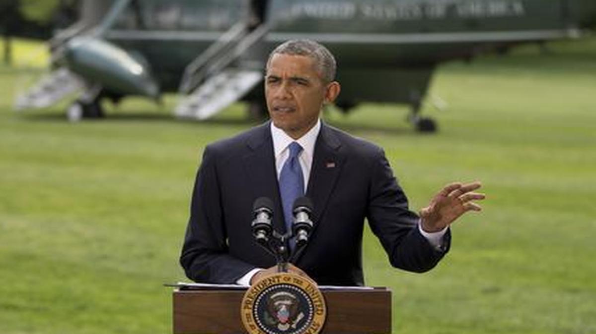 
President Barack Obama talks about his administration's response to a growing insurgency foothold in Iraq, Friday, June 13, 2014, on the South Lawn of the White House
