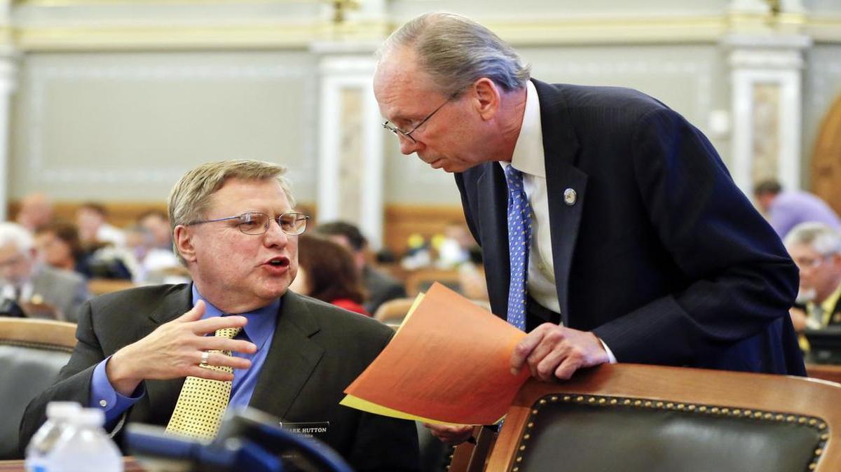 Rep. Mark Hutton (left), a Wichita Republican, and Rep. Marvin Kleeb, an Overland Park Republican, talked before a tax bill debate Friday on the Kansas House floor.