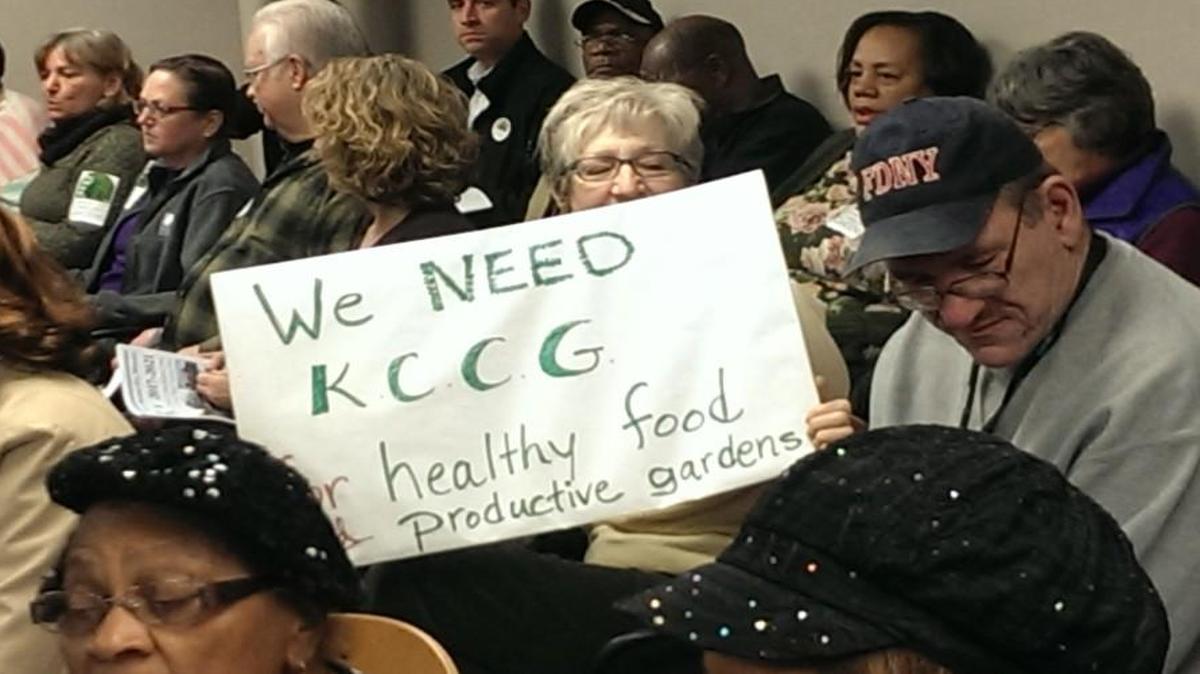 Beth Seberger raised a sign in support of the Kansas City Community Gardens program during a Housing Committee hearing on federal grant funding Tuesday. Seberger is a volunteer in community gardens through Metro Lutheran Ministries.