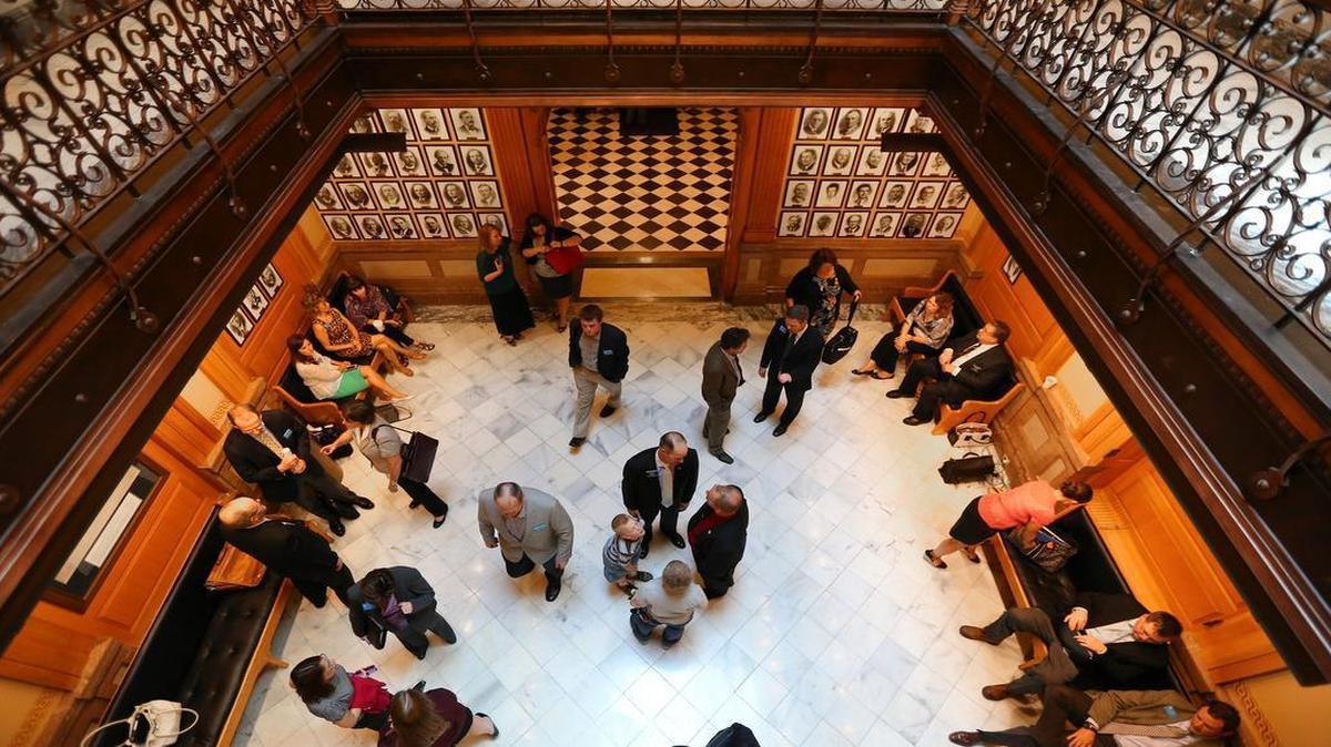 
Lawmakers and lobbyists congregate outside the House chamber during one of the many fits and starts standing between the Kansas Legislature and a deal that would raise taxes to fill the state’s budget hole.
