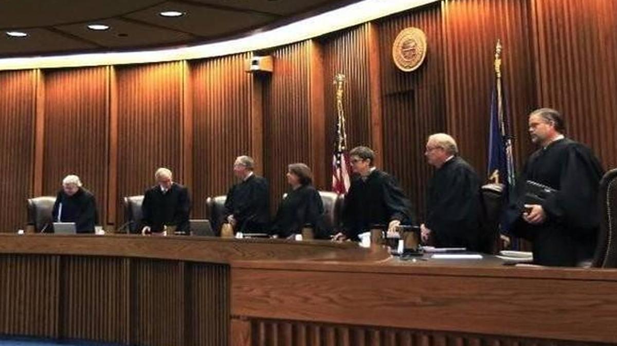 The Kansas Supreme Court is considering whether a law that removed hearings for tenured K-12 teachers who had been fired violates the state constitution.