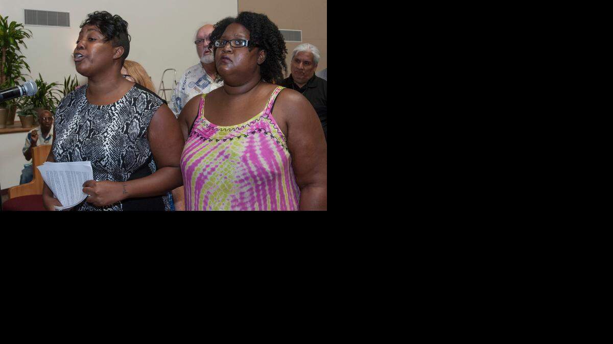 
With tears streaming down her face, Jasmine Taylor (left) spoke Saturday at St. James United Methodist Church about a confrontation she had with police just last week. Janae Bowers stepped up to stand by Taylor.
