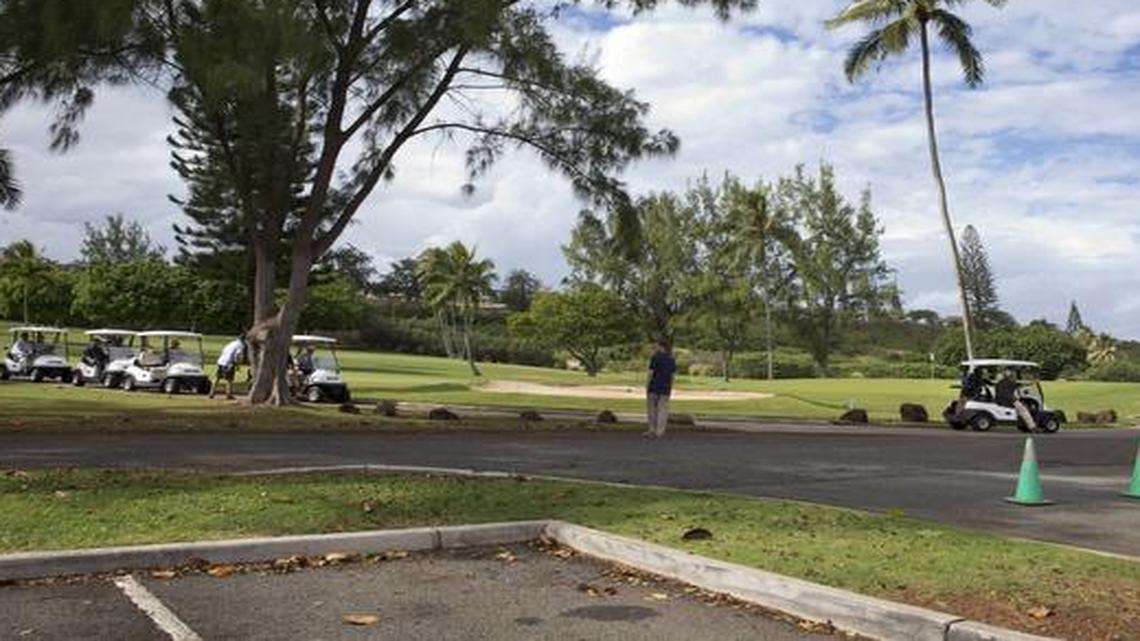 
President Barack Obama drives away from the 18th hole in a golf cart, far right, at Marine Corps Base Hawaii's Kaneohe Klipper Golf Course in Kaneohe, Hawaii
